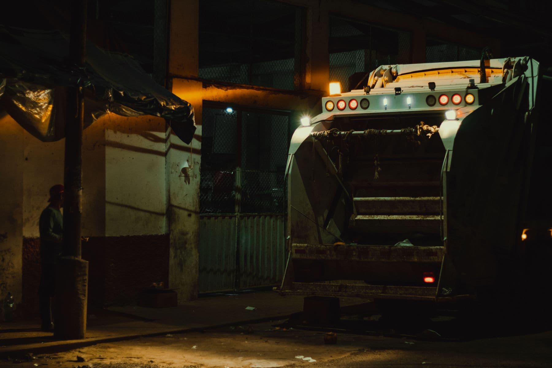 Rear-loading collection vehicle working a night round